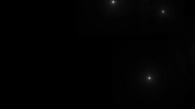 Flashing lens flare camera flashes of photographers animation on black background. Many of flash lights with random switch. Flashing lens flares seamless looping. Lots of photo camera flashing.