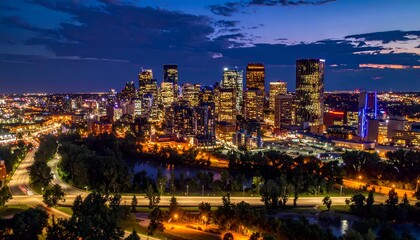 Obraz premium Illuminated city skyline at dusk with a river and highway