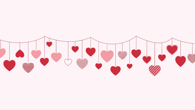 Decorative hanging heart garland with various red and pink hearts on strings against a soft light pink background.