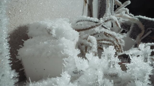 Winter frost decorates. Frozen crystals embellish surfaces beautifully. Ice formations silently cover ropes and poles. Frost adorns fibers with shimmering icy crystal designs