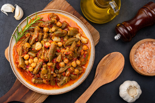 Freshly cooked okra dish on black stone table background