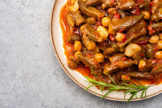 Freshly cooked okra dish on stone table background