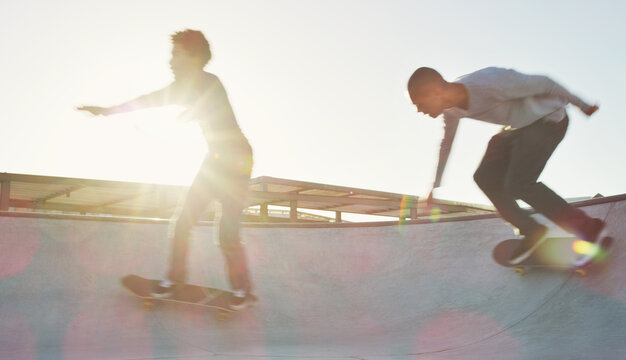 Skateboard, men and skating balance at park for action stunt, trick performance and flare. Skater, friends or energy on halfpipe in summer for adventure, extreme sport or practice freestyle technique
