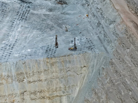 Panoramic view of a drilling and blasting work area with enormous mining drilling machines