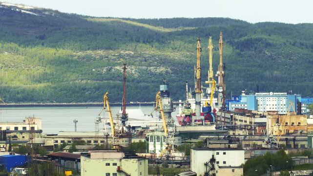 Murmansk, Russia - June 7, 2020: The aircraft-carrying cruiser Admiral Kuznetsov at the pier at the repair base of the 35th Shipyard. View from the Zeleny Mys Hill.