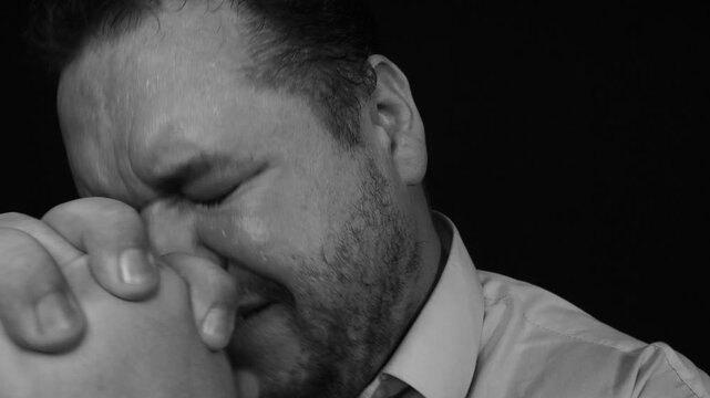 A grown man cries, prays and hopes for a miracle.