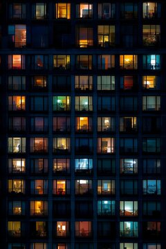 Lit Windows of a Modern Apartment Building at Night