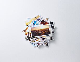 Fototapeta premium Stack of travel memories photos on white background 