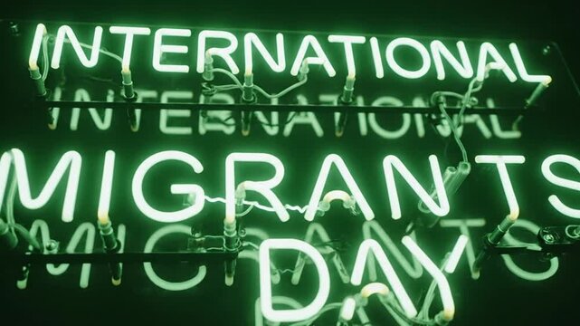 Green neon sign displaying International Migrants Day on dark background