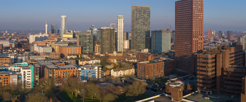 Aerial panorama of Birmingham Westside skyline at late golden hour.