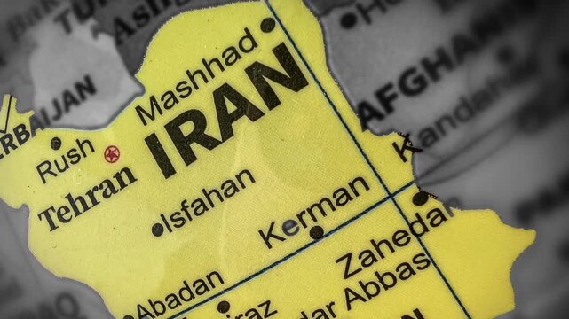 Close-up of Iran map showing Tehran and Mashhad on the map top view 4k footage, yellow highlighted area