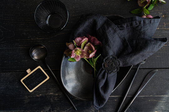 Spring themed table setting with fresh hellebore flowers