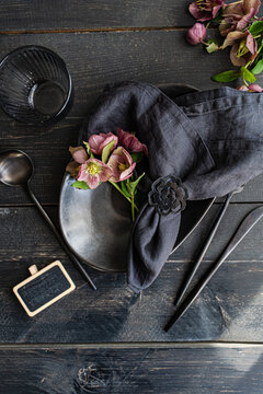 Spring themed table setting with fresh hellebore flowers