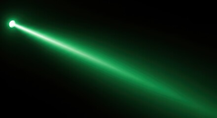 Bright green laser beam with glowing effect shining diagonally on black background