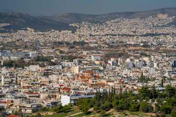 Obraz premium Wide view of Athens spreading across the Attica basin, seen from a hill overlooking the historic city