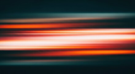 Abstract motion blur of horizontal orange and white light trails on a dark background