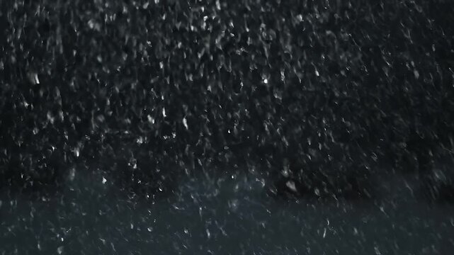 A dark, abstract depiction of falling white shapes against a dark gray background