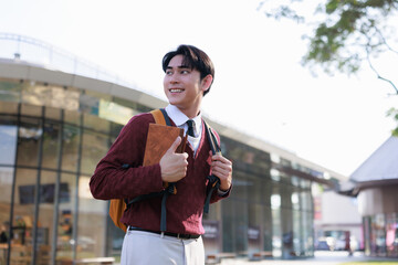 Young student smiling, looking forward on university campus