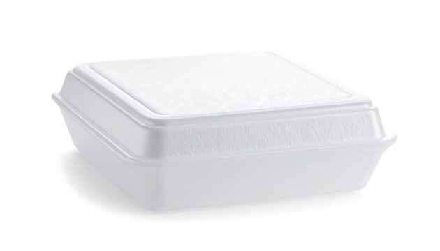 White styrofoam food container with a lid, casting shadow on a white background in a simple studio shot