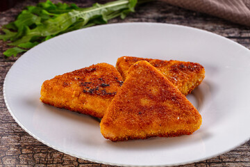 Fried golden fish cutlets triangles