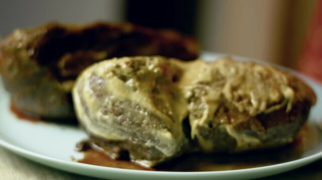 Coating the roasted beef tenderloin with Dijon mustard