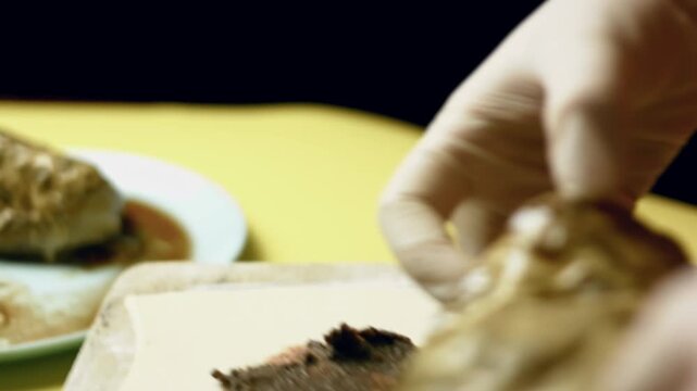 Person puts the roasted seasoned beef tenderloin over the puffy pastry with pate