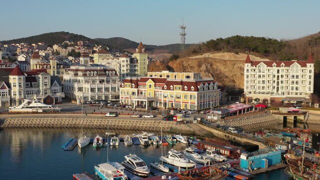 Dalian Harbor with Colorful Waterfront Buildings and Moored Boats