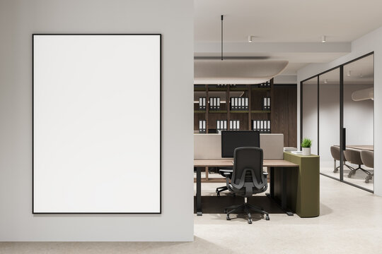 Large empty poster mockup on a clean interior wall next to a modern office workspace layout and contemporary design backdrop.."" 3D Rendering