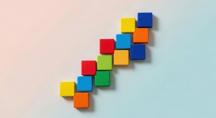 Obraz premium Colorful wooden blocks arranged in a rising step pattern, concept of progress and success