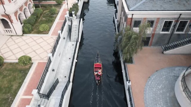 Red Gondola Gliding Through Venice-Style Canal in Dalian