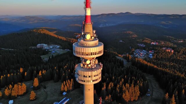 Tower Snezhana on peak of Snezhana covered with spruce forests in Rhodope mountains