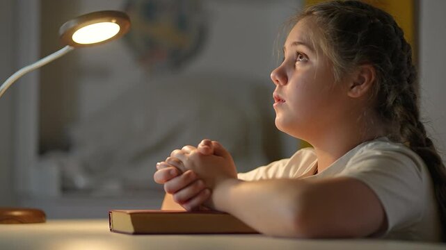 Child prays with head bowed and hands pressed. Belief expressed in quiet space. Hands show steady devotion. Peace surrounds child in prayer. Faith, belief, and devotion meet in child silence.
