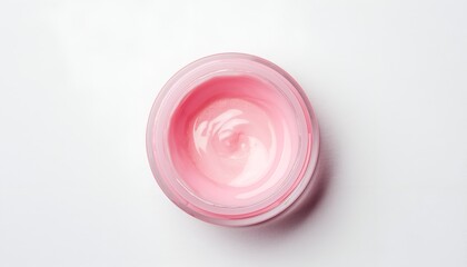 Cosmetic pink cream in open jar on white backdrop for skincare and beauty product use