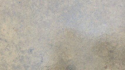 Obraz premium Wet polished concrete floor texture with damp stains. Close-up of a damp cement surface with water absorption patterns. Detailed view of a wet concrete floor after rain.