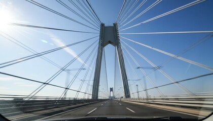 Naklejka premium Cable-Stayed Bridge Pylon with Radiating Cables under Clear Blue Sky while Driving