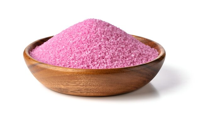Wooden bowl filled with bright pink Himalayan bath salts against a white background