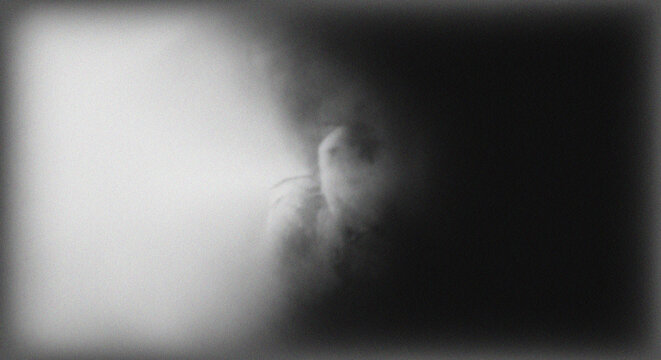 Ethereal human figure with soft blur and prominent monochrome film grain