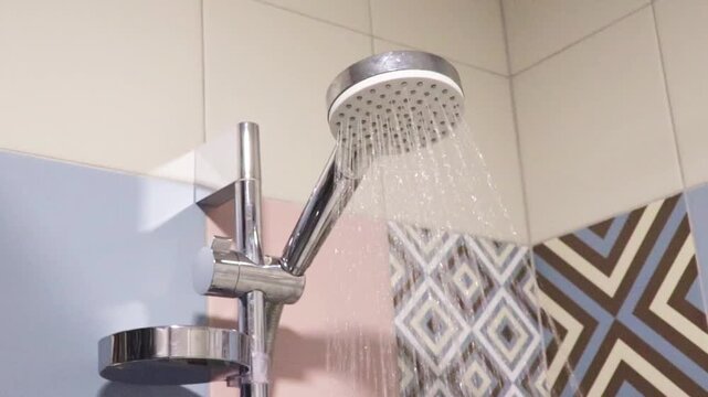 Shower set with running water, featuring a hand shower and a riser rail. Indoor