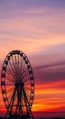Large observation wheel silhouettes against vibrant twilight sky colors