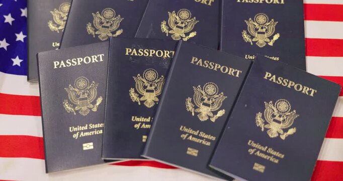 Stack of United States passports on American flag background