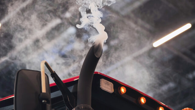 Truck exhaust pipe emitting smoke, symbolizing air pollution and climate change