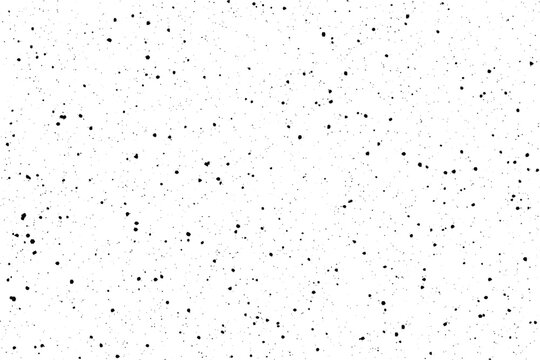 Scattered tiny black speckles randomly dotting a bright white surface creating a distressed overlay effect