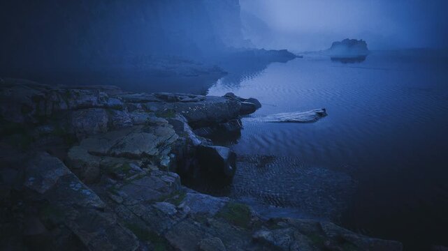 Nocturnal rocky outcrop with distant ship cutting horizon, turbulent ripples and scattered spray, brooding indigo sky with faint beacon glow, sense of isolation