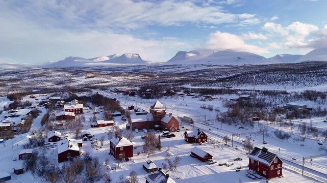 Abisko train station and village, in winter, with the famous Lapporten mountains in the distance, Sweden.