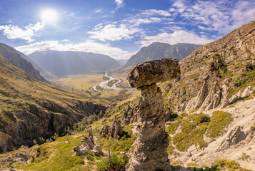 Fototapeta premium Aerial panaramic view to Natural formations stone mushrooms in Akkurum tract against blue sky, rock formations of a bizarre shape in sunny day. Ulagan Chulyshman river Valley, Altai Republic, Russia