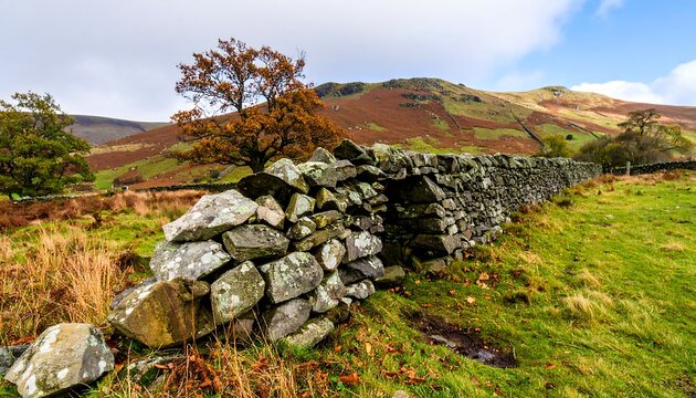 Autumnal stone wall, gap in dry-stone fence,  mountain backdrop