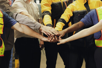 Team multi-ethnic workers, men and women, join hands to join forces to join forces to work for the industry for success. Teamwork and professional colleagues : Workers' hands, teamwork concept.

