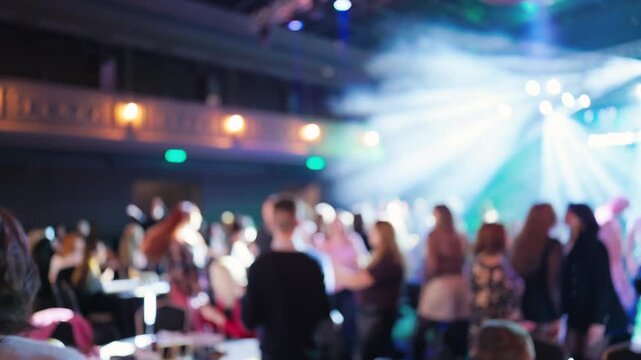 Blurred cabaret dinner with table service and candlelight, seated guests watching performer, relaxed acoustic vibe and soft spotlight