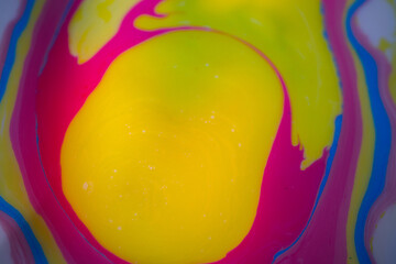 A macro abstraction of neon pink liquid paint forming a smooth spiral swirl surrounded by bright...