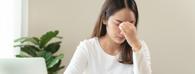 Eye problem concept, fatigue asian young woman tired eyes, irritated rubbing eye dry relief vision pain after work on laptop computer, eye strain, hand holding glasses, suffer migraine, bad blurry